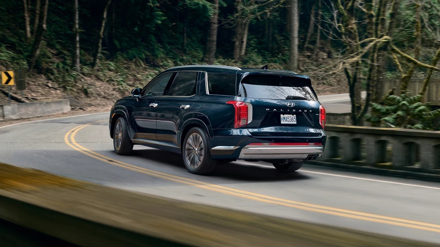 Dark blue 2024 Hyundai Palisade on a winding road