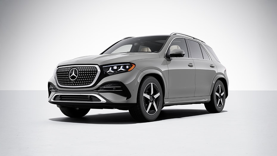 Silver Mercedes-Benz GLE SUV with AMG Line diamond grille and alloy wheels shown from a front three-quarter angle against a plain studio background at Kunes Mercedes-Benz of Sycamore.