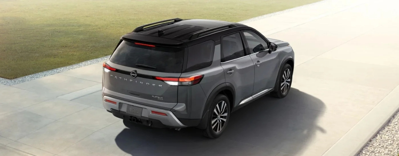 Grey 2025 Nissan Pathfinder Platinum is reversing on a driveway