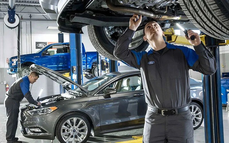 image of man doing maintenance under vehicle