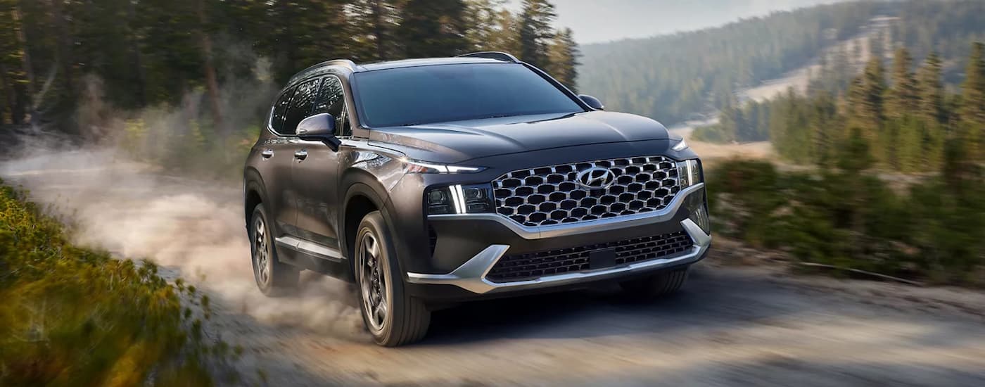 Grey 2022 Hyundai Santa Fe driving off-road on a dirt trail