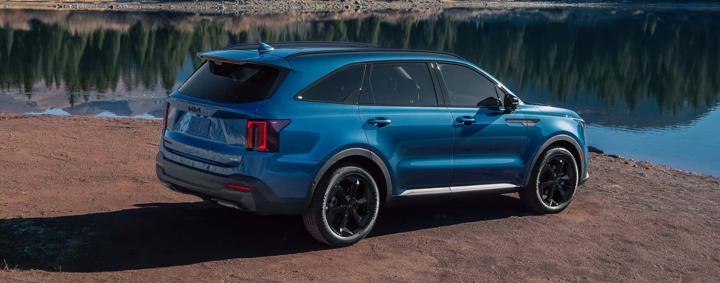 Blue 2026 Kia Sorento HEV parked near a lake