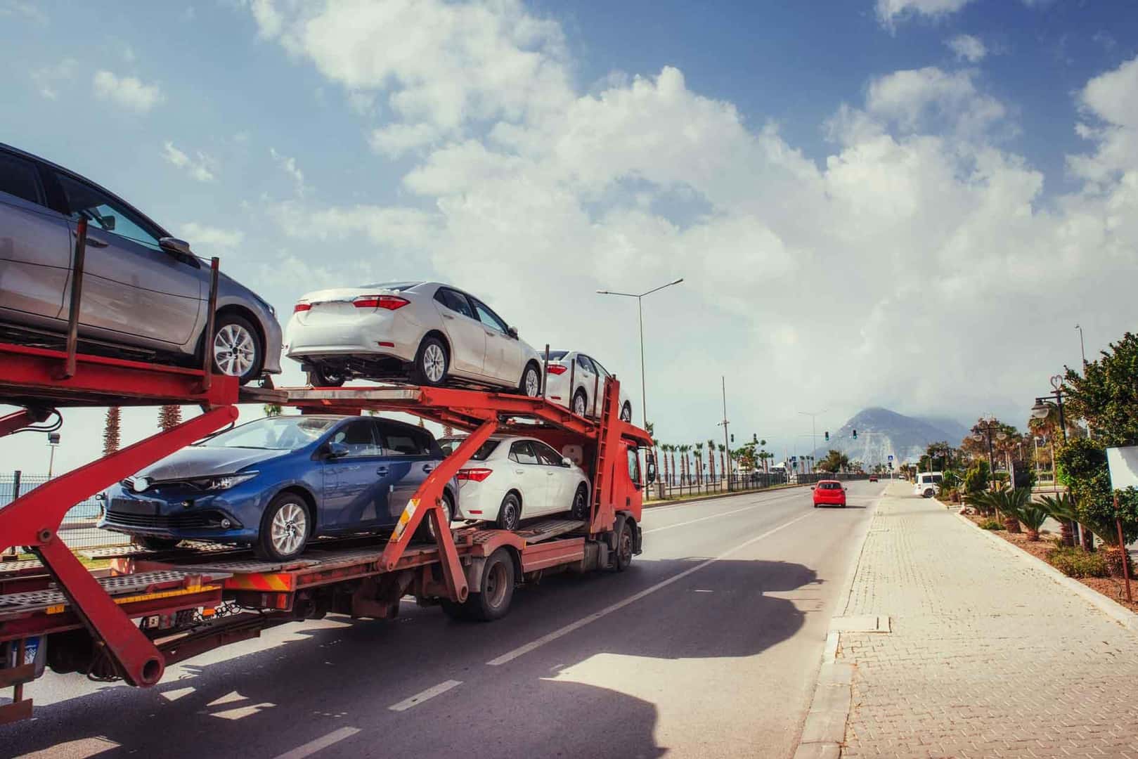 vehicles being delivered on a delivery truck