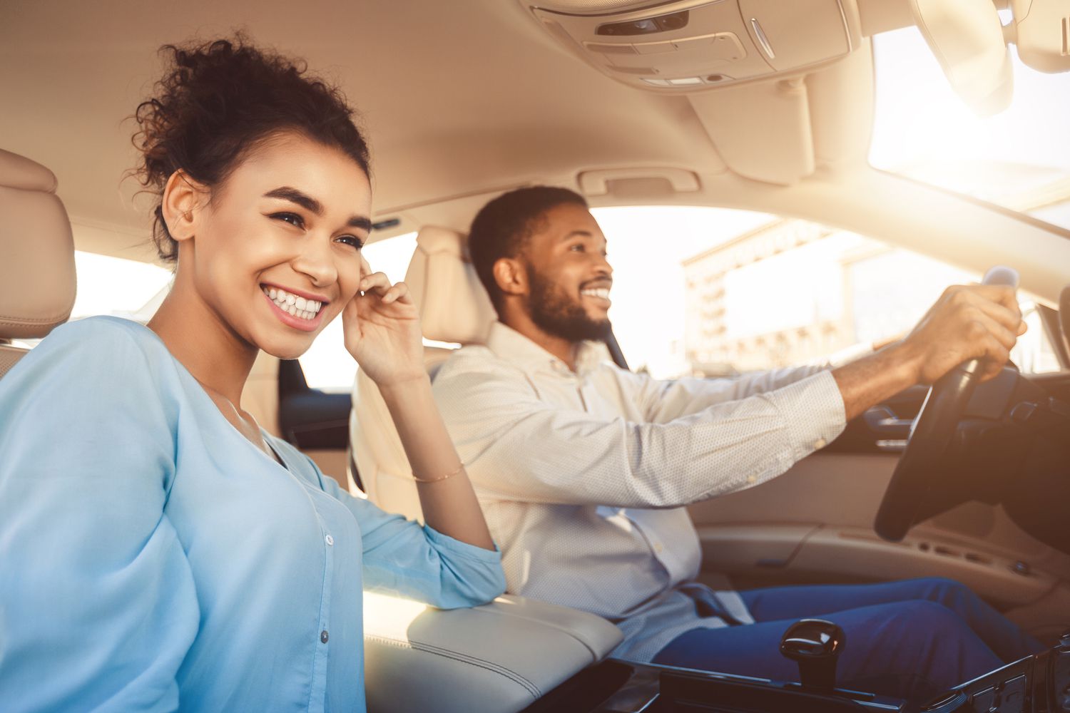 a happy couple enjoying a car ride while listening to Kunes Auto Group Spotify playlists