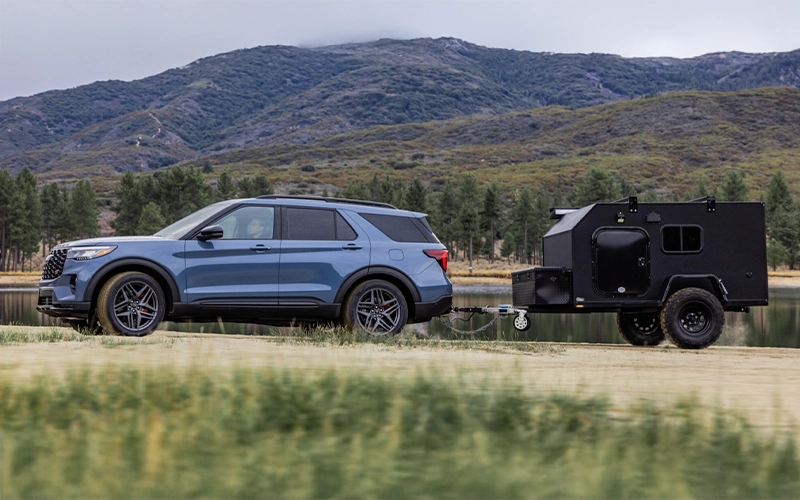 image of silver ford explorer towing boat by lake