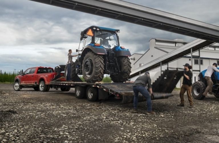 Red 2024 Ford Super Duty Towing Heavy Equipment