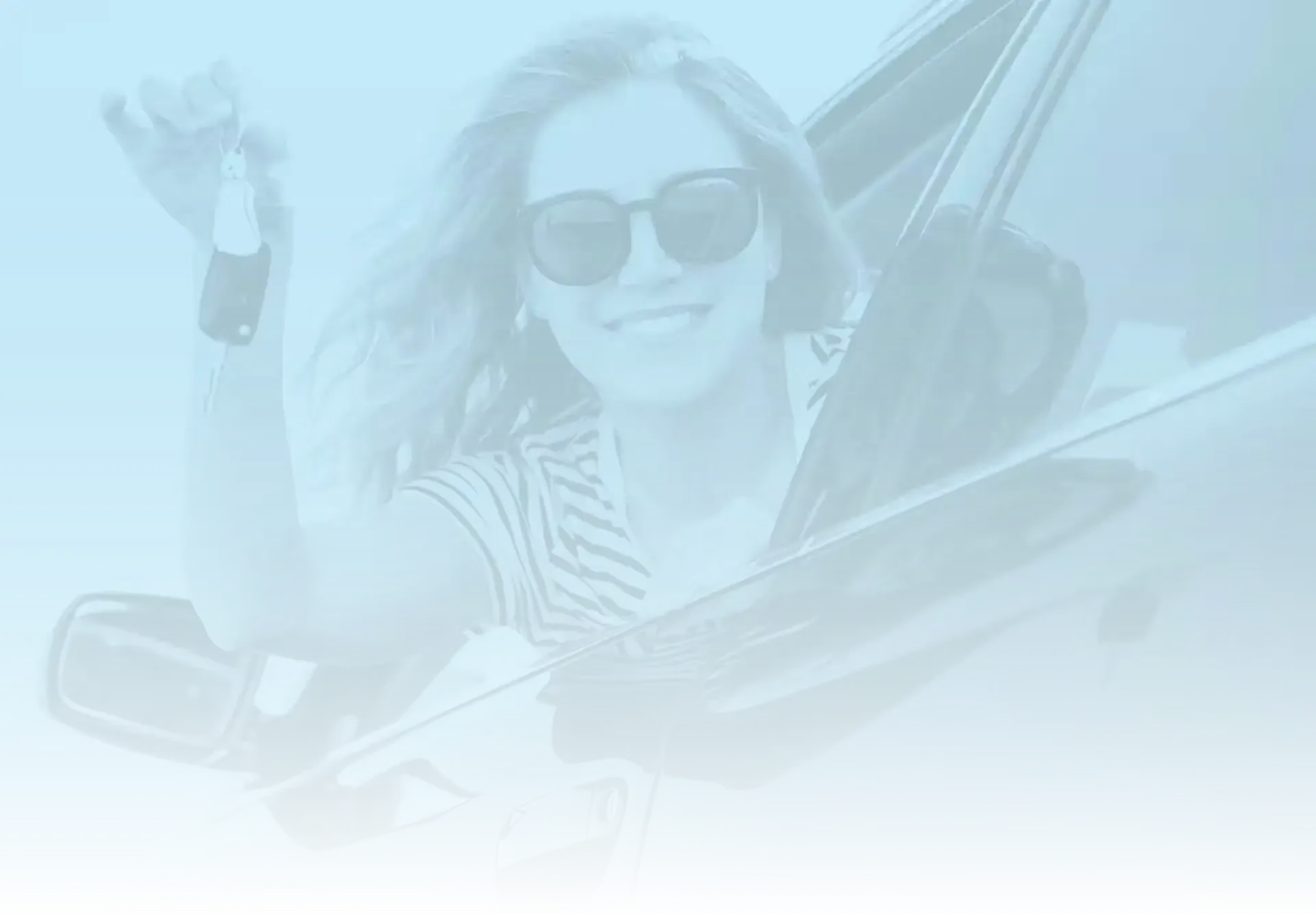 Woman leaning out driver's window holding keys and smiling