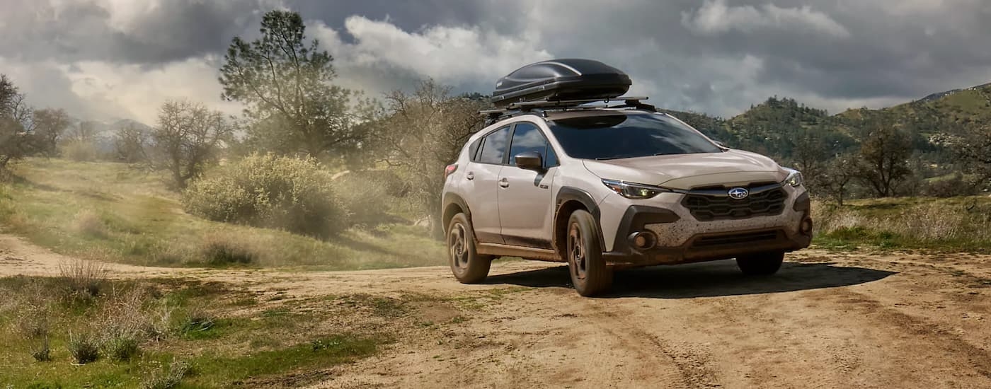 White 2026 Subaru Crosstrek Hybrid off-roading.