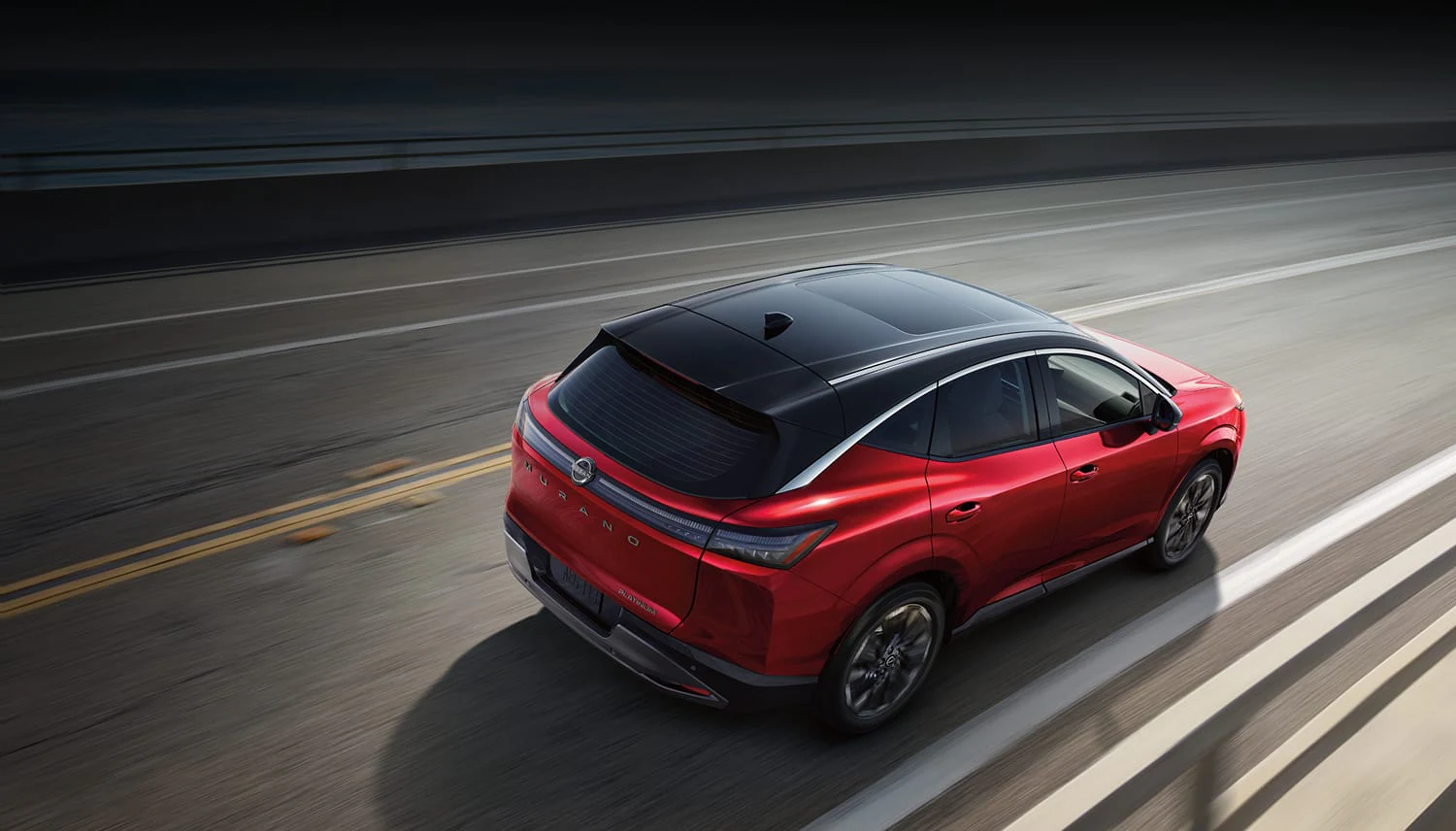 2027 Nissan Murano in gray, front three-quarter view on a country road