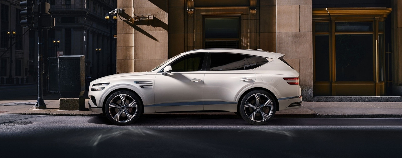 White 2025 Genesis GV80 for sale near Wetumpka parked in front of a building