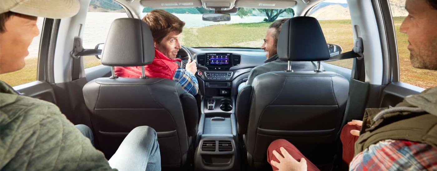 Group of friends are shown driving a 2022 Honda Ridgeline RTL-E