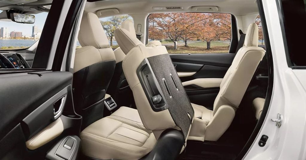 Open rear door of a Subaru Ascent showing easy access to the second-row captain's chairs