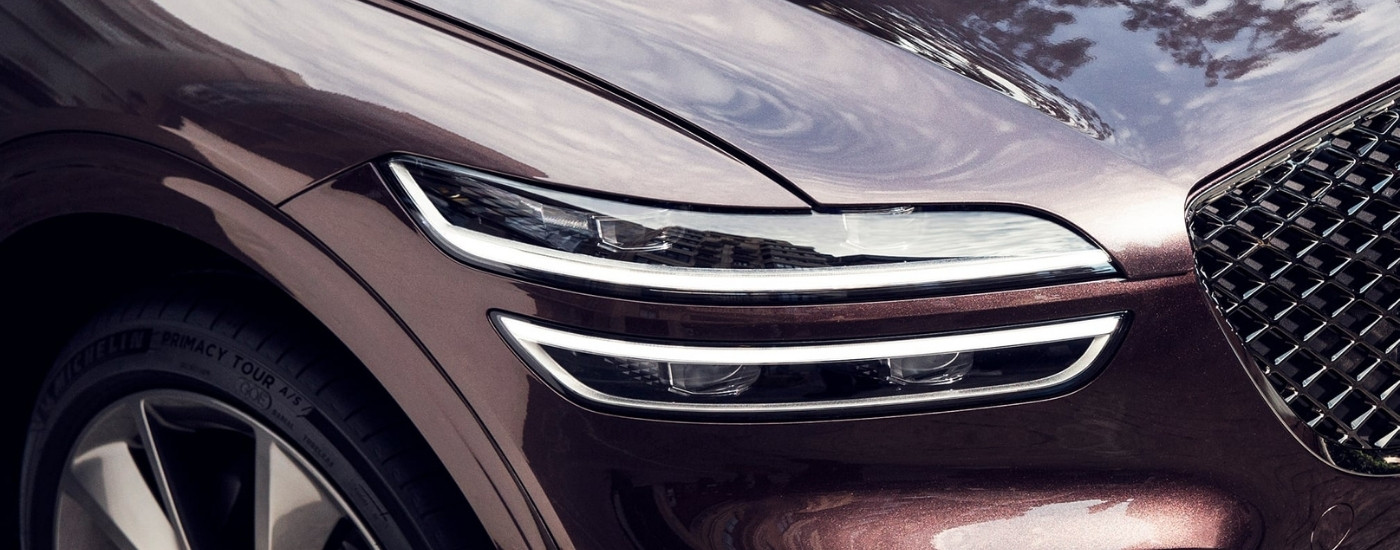 Headlight on a purple 2022 Genesis GV70