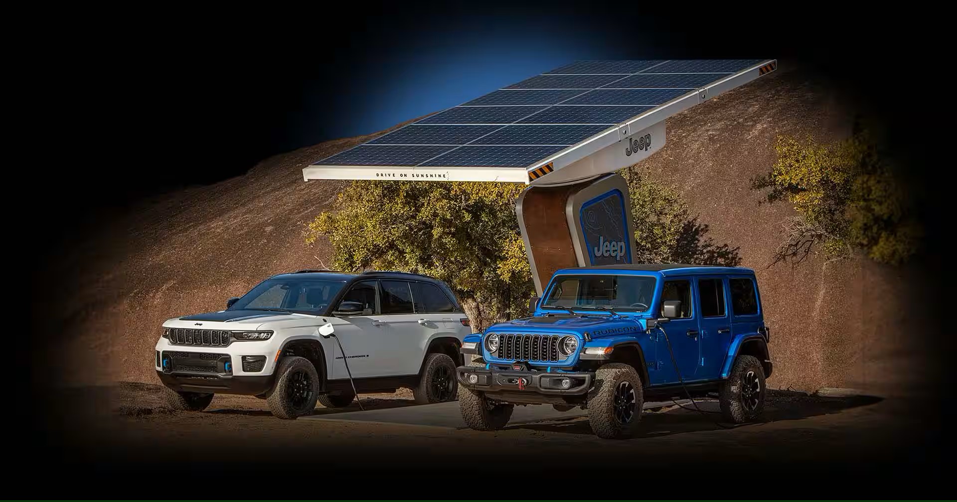 2 hybrid vehicles charging at a solar station in the wilderness