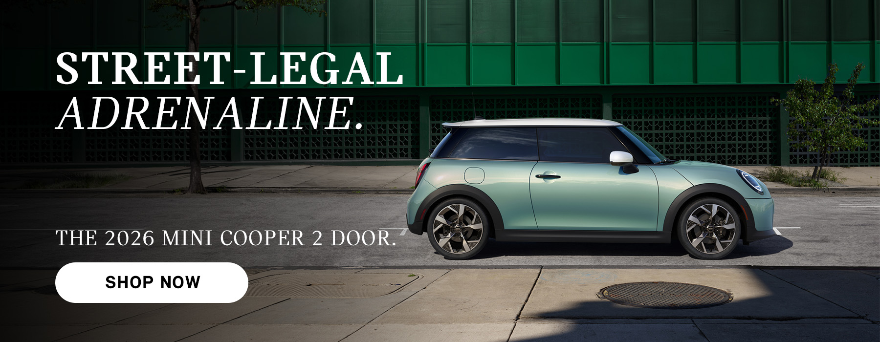 Mint green MINI Cooper 2-door parked on a city street with building backdrop, with ad text promoting the 2026 model and a “Shop Now” button.