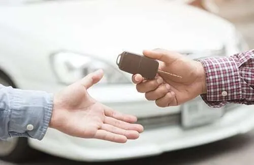 Car keys being handed to a new owner
