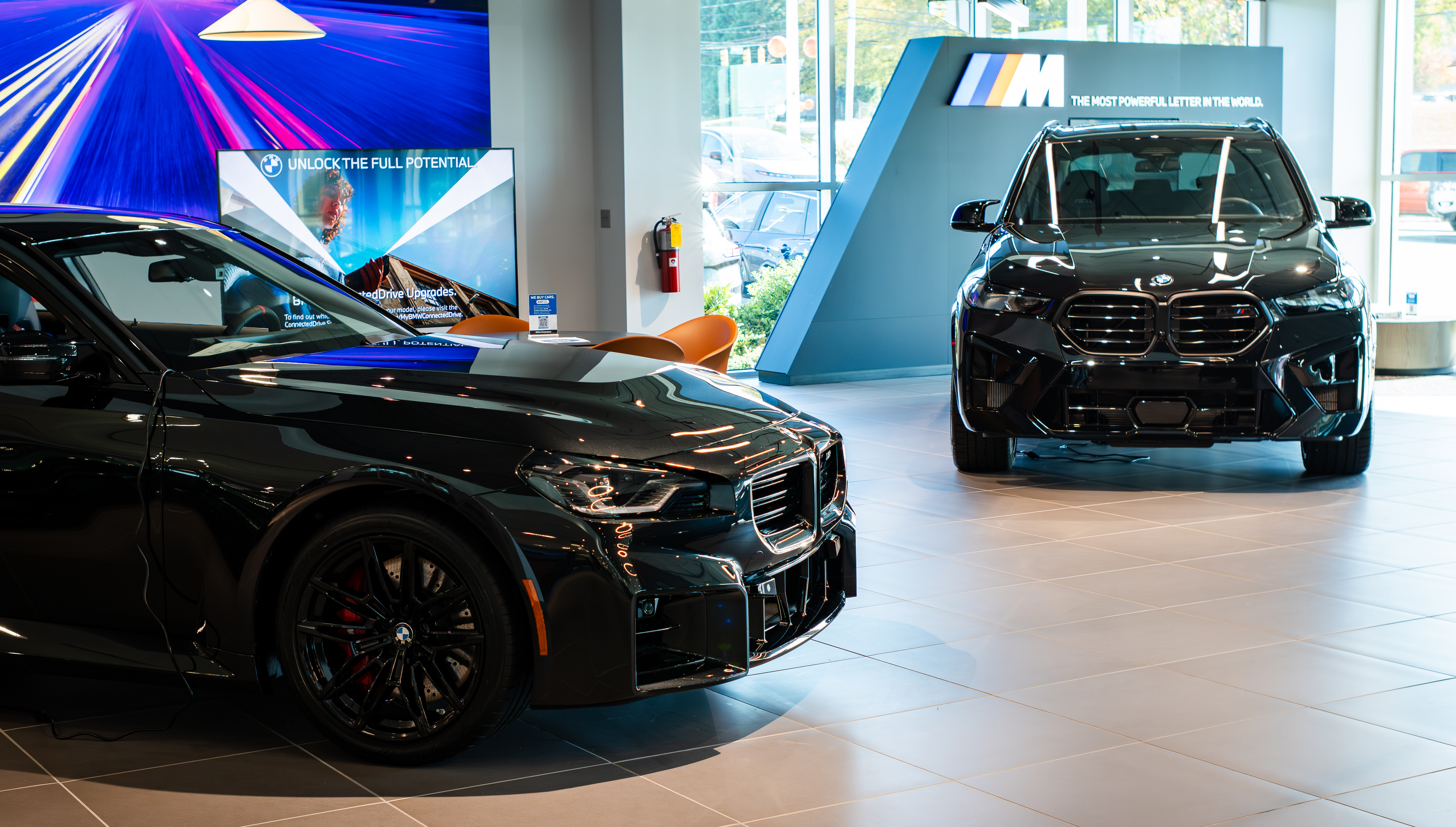 Two BMW vehicles in the BMW of Greensboro showroom