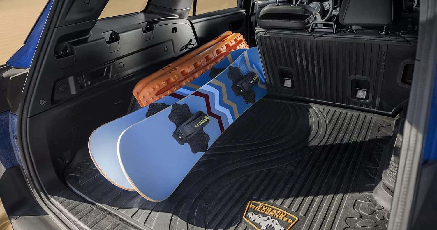Snowboards loaded in a Subaru Outback cargo area