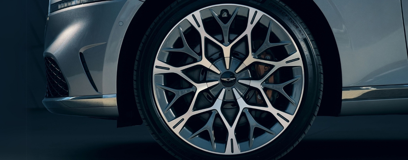 Close-up of the front driver side wheel on a silver 2025 Genesis G90