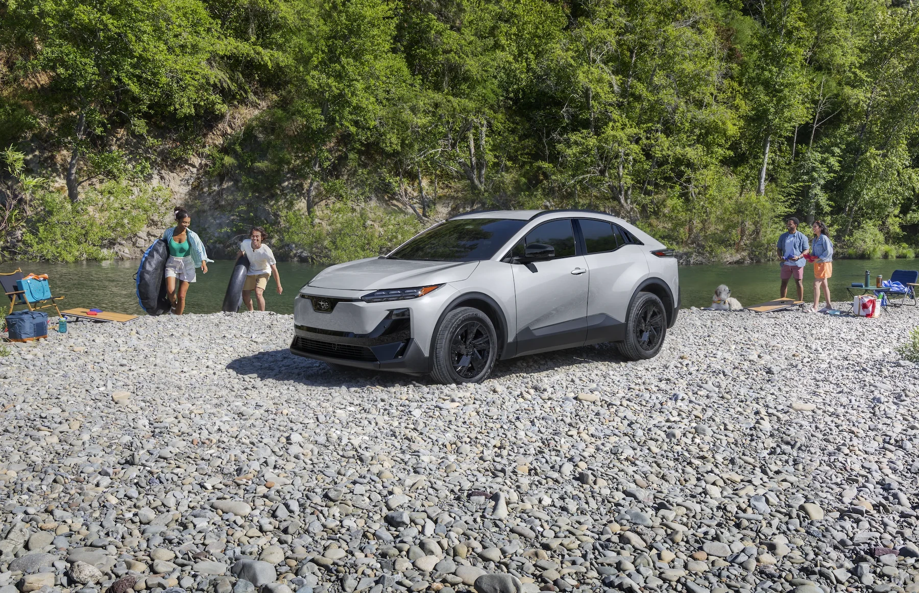 A static image of Uncharted Sport in Metropolis Gray Metallic parked on a rocky bank of a river.