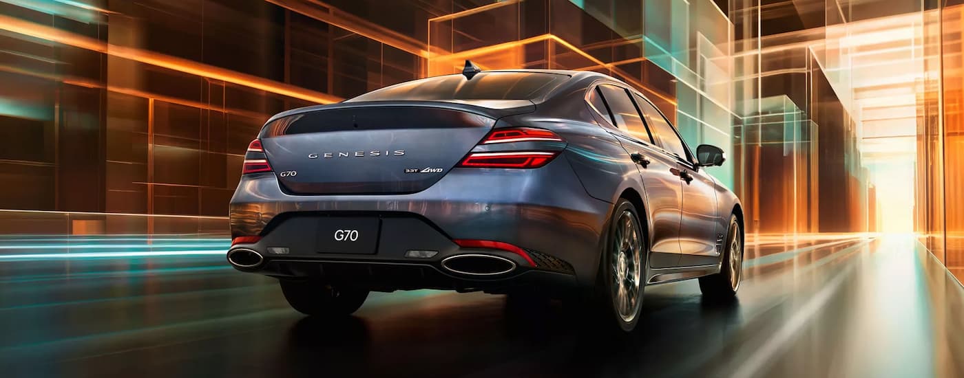 Grey 2026 Genesis G70 driving down an open road.