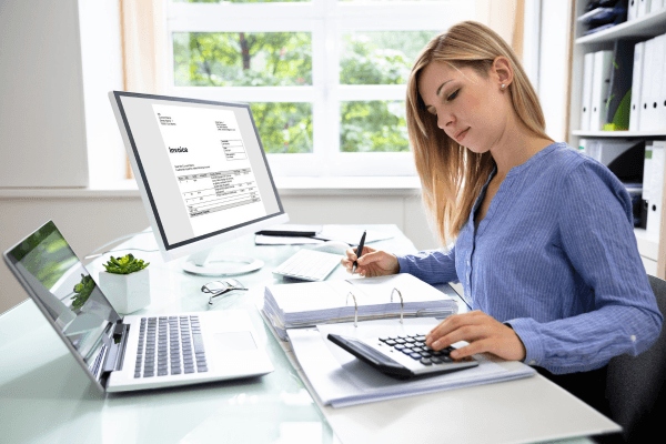 Woman at a desk calculating car loan figures