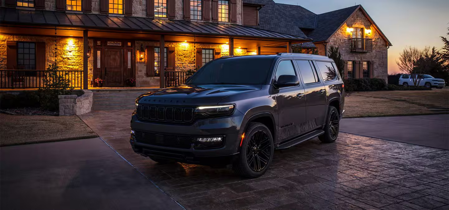 A black suv sitting in front of a house.