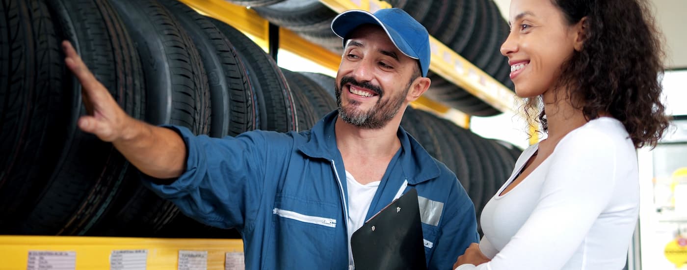 Customer and mechanic talking about tires at a tire shop in Rochester