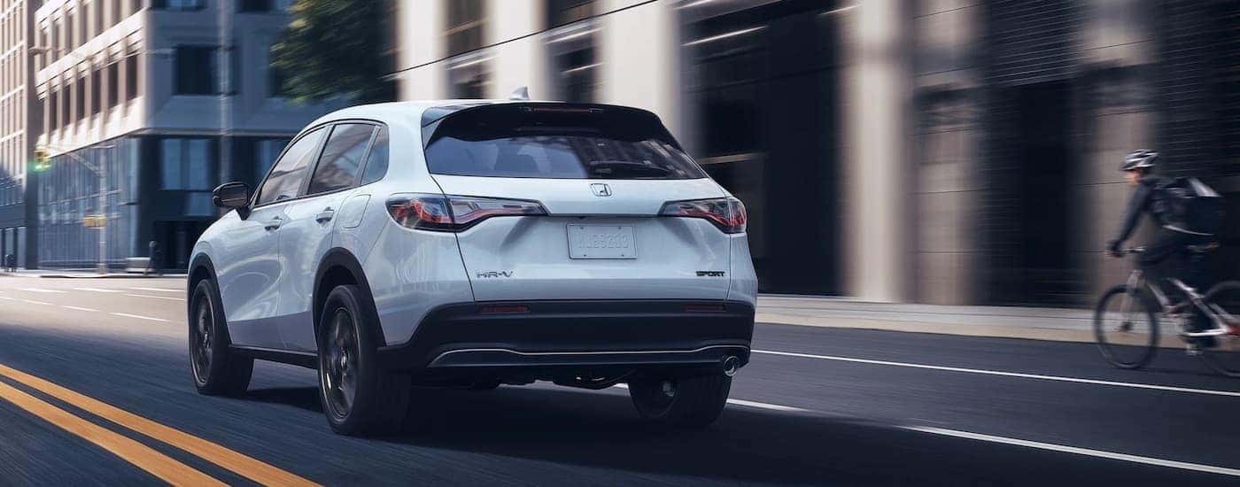 A white 2024 Honda HR-V is shown from the rear at an angle.