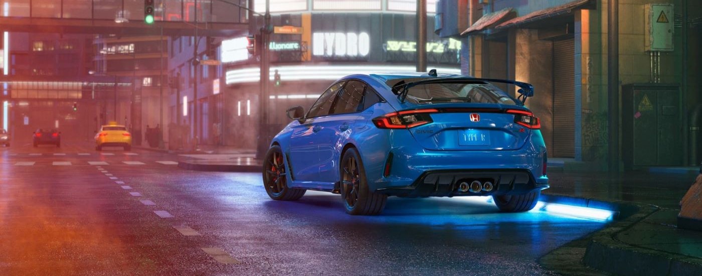 Blue 2024 Honda Civic Type R for sale driving on a city street