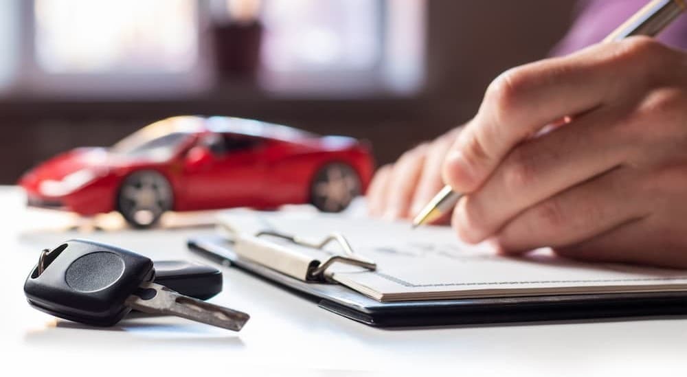 A person signing papers.