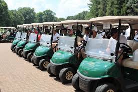 Community members participating in a charity golf outing
