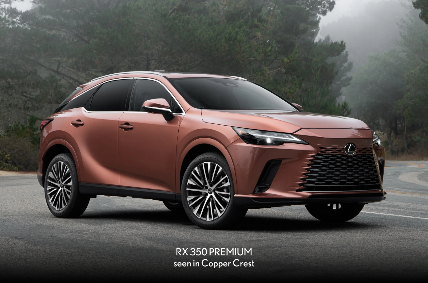 2026 Lexus RX 350 Premium in Copper Crest, front three-quarter view on a misty forest road.
