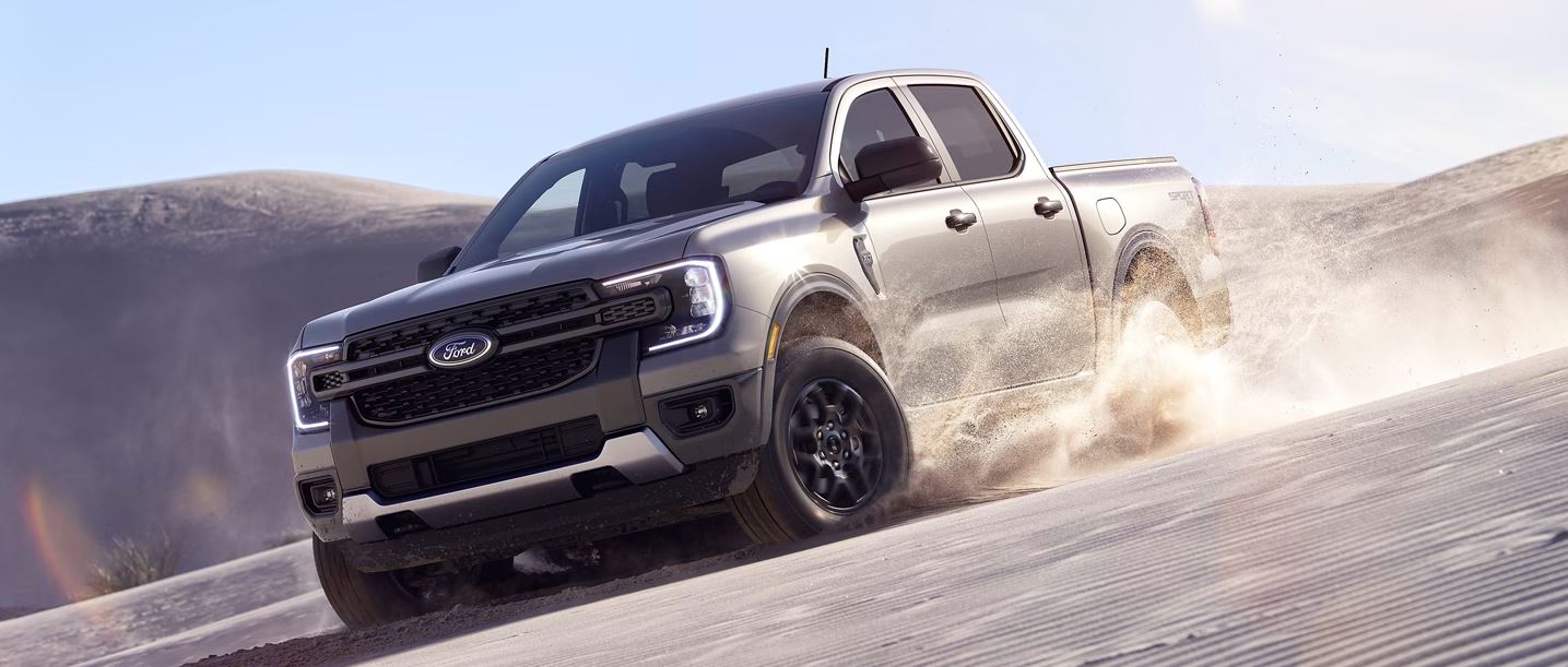 gray 2024 Ford Ranger off-roading down a sand dune