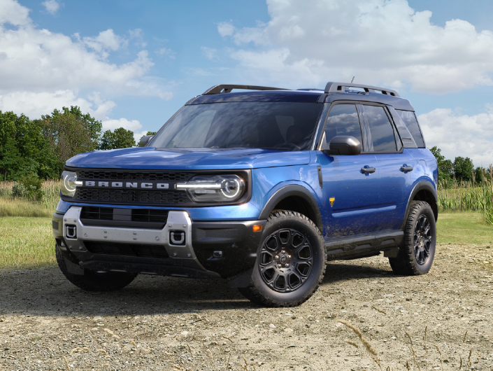 Blue Bronco Sport on a dirt patch in a field