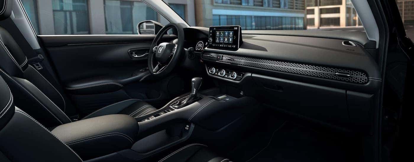 The black interior of a 2024 Honda HR-V is shown from the passenger side.