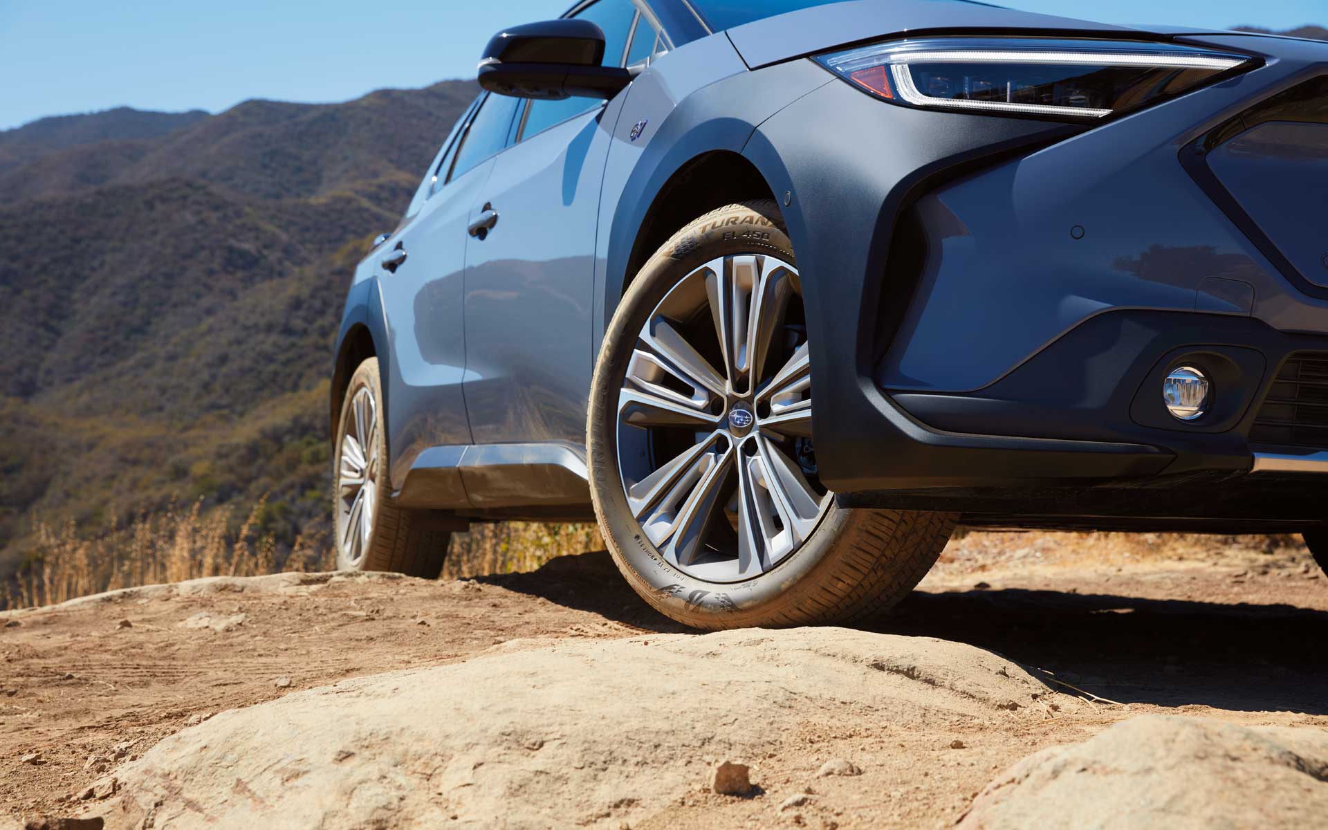 Subaru Solterra wheel climbing over rocks using X-MODE