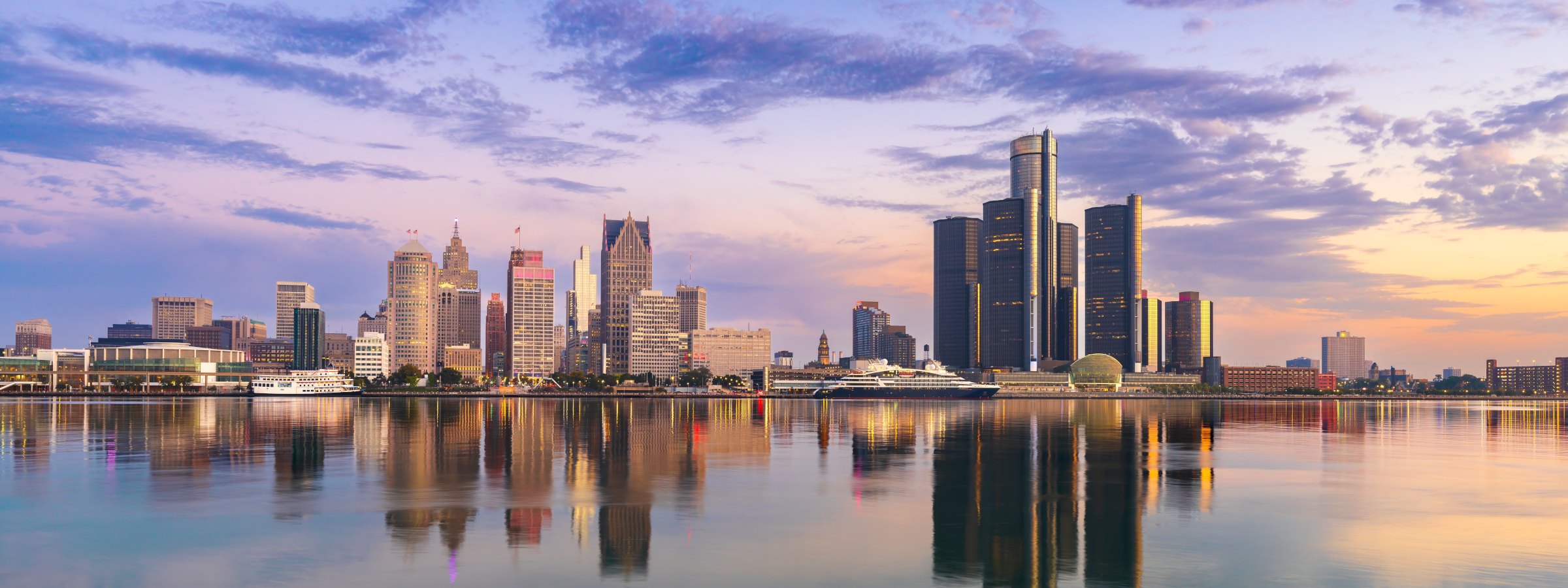 Detroit skyline reflected in the river at sunset