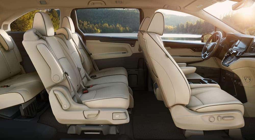 The tan interior of a 2024 Honda Odyssey is shown from the passenger side.