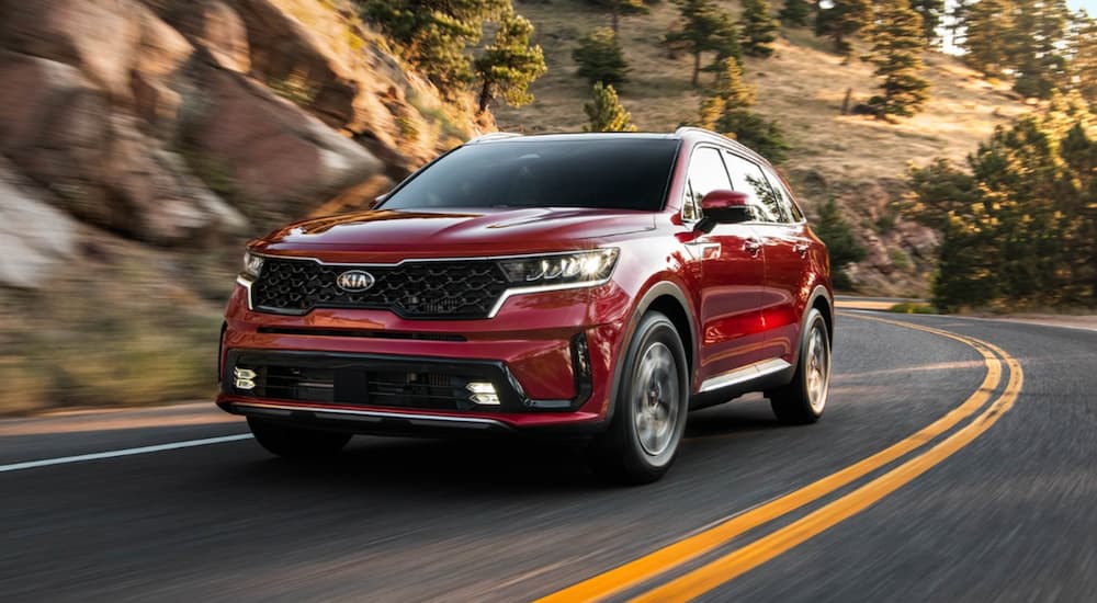 Red 2021 Kia Sorento rounding a corner