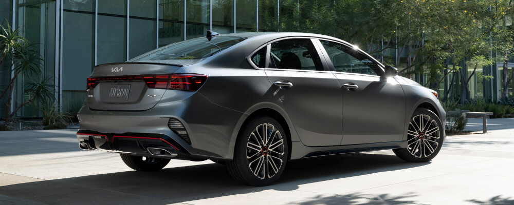 2023 Kia Forte GT in gray parked outdoors, showcasing sleek design and sporty features, relevant to fuel efficiency discussions.