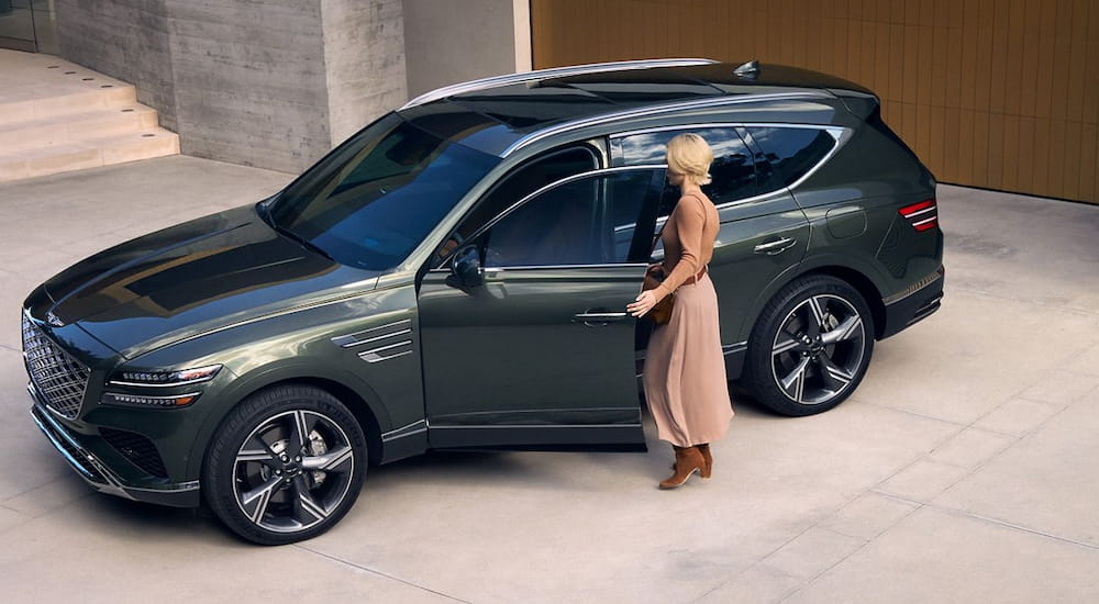 Green 2026 Genesis GV80 parked on a driveway.