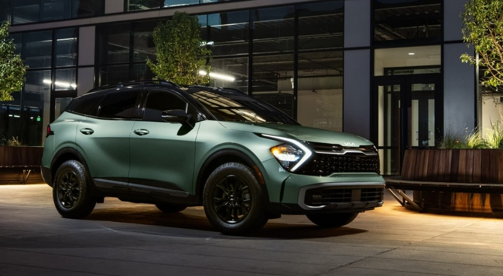 Green 2025 Kia Sportage X-Pro Prestige parked in front of a building