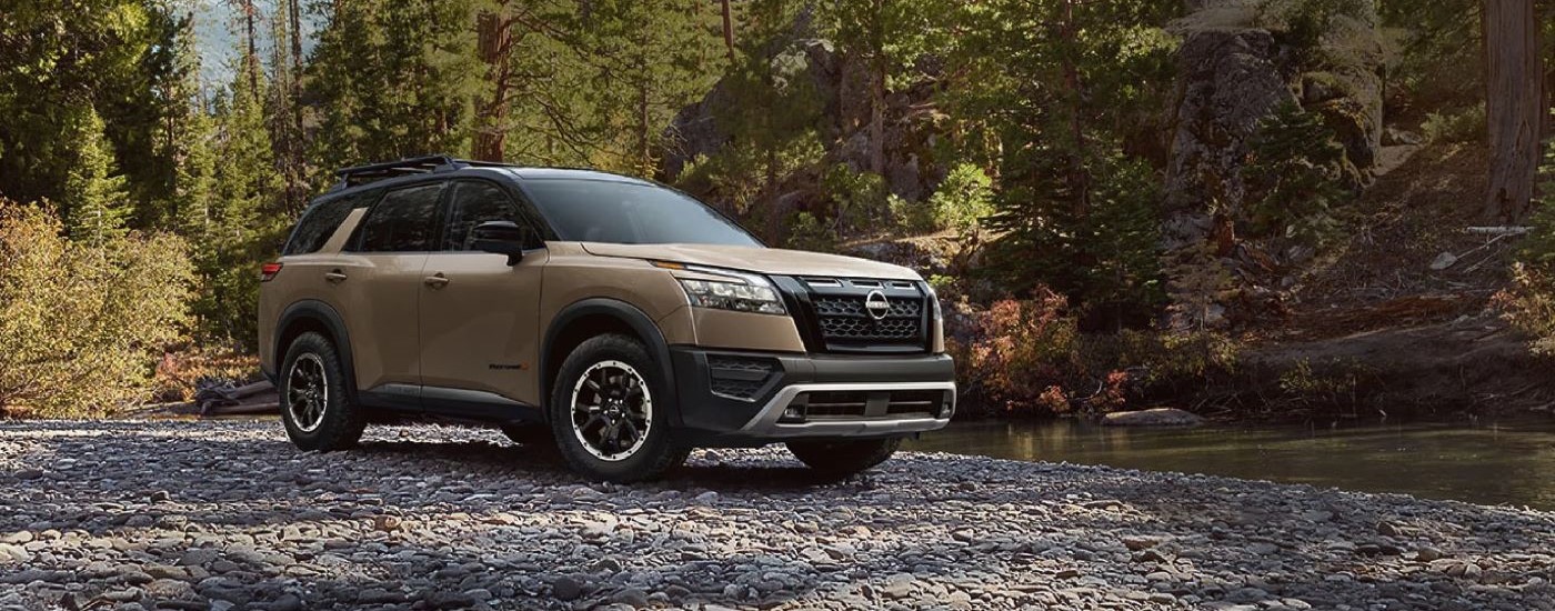 Tan 2023 Nissan Pathfinder Rock Creek parked near a river