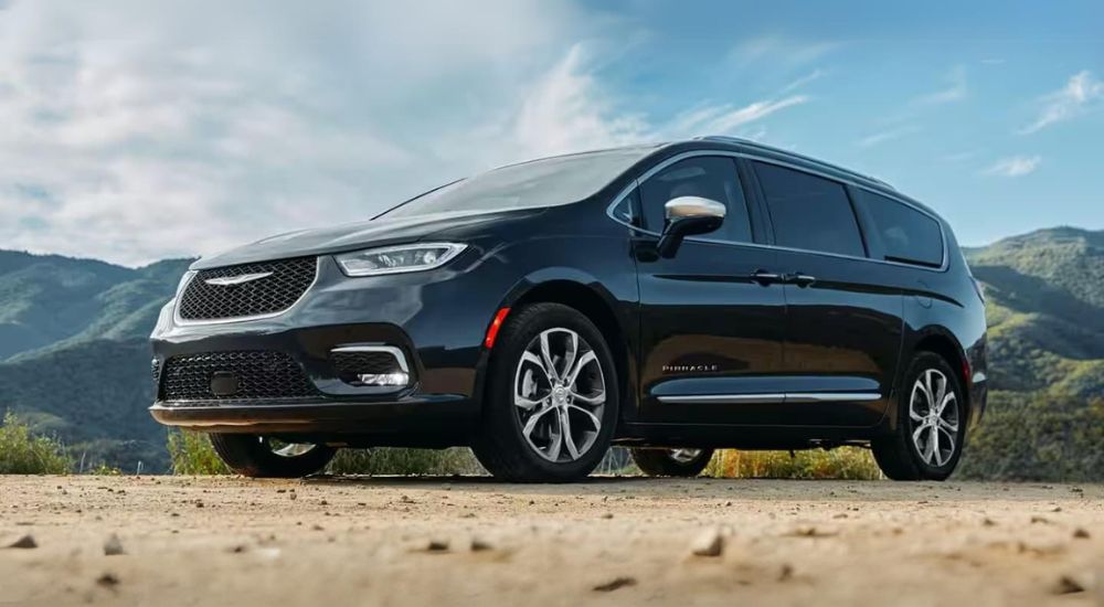 A black 2021 Chrysler Pacifica Pinnacle is shown from the front at an angle.