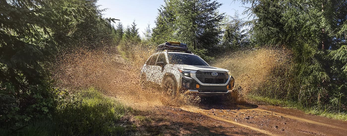 White 2026 Subaru Outback off-roading in mud