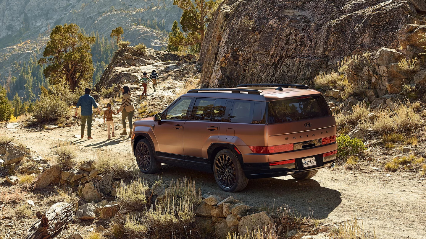 A family next to a suv.