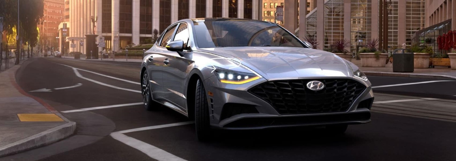 A gray  2020 Hyundai Sonata drving on the road.