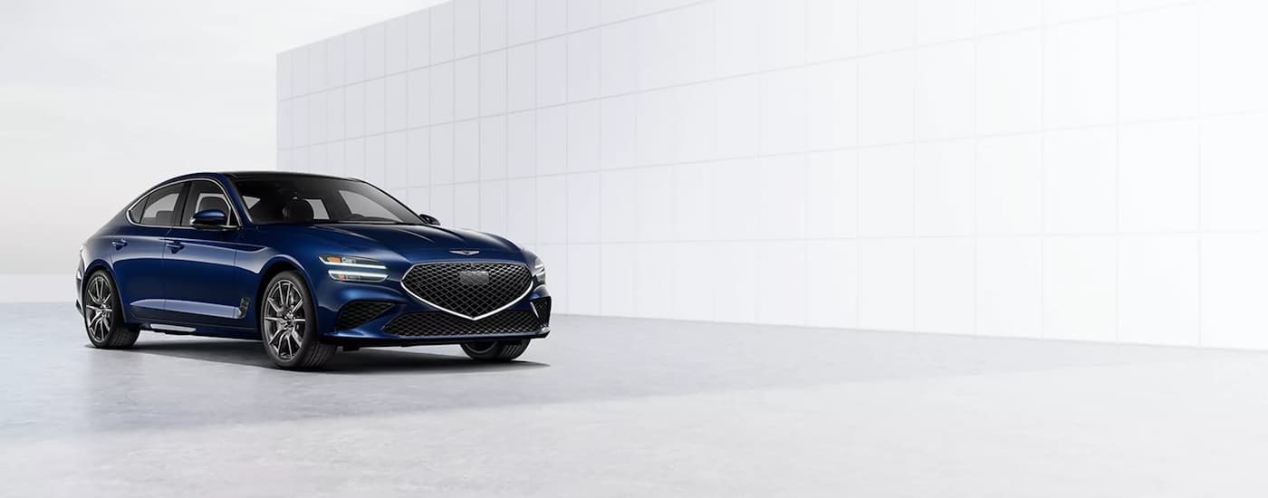 Blue 2026 Genesis G70 parked in a showroom.