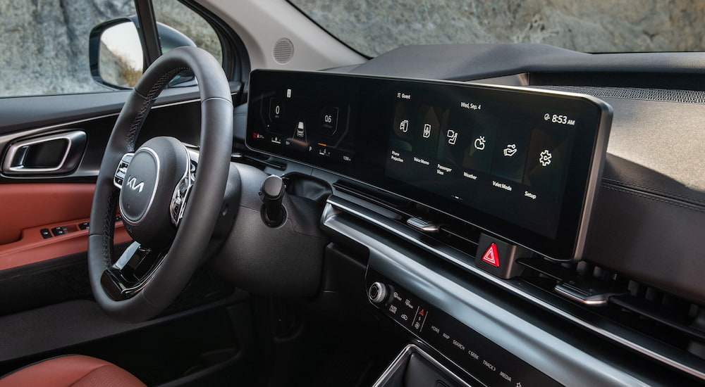 Dashboard screen and steering wheel inside of a 2026 Kia Carnival